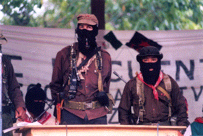 Subcomandante Marcos and Comandante Tacho in La Realidad, Chiapas, 1999, by Cesar Bojorquez, licensed under CC BY 2.0. Depicts Subcomandante Marcos, an Ejército Zapatista de la Liberación Nacional revolutionary, alongside Comandante Tacho. Subcomandante Marcos and Comandante Tacho in La Realidad, Chiapas, 1999, by Cesar Bojorquez, licensed under CC BY 2.0. Depicts Subcomandante Marcos, an Ejército Zapatista de la Liberación Nacional revolutionary, alongside Comandante Tacho.